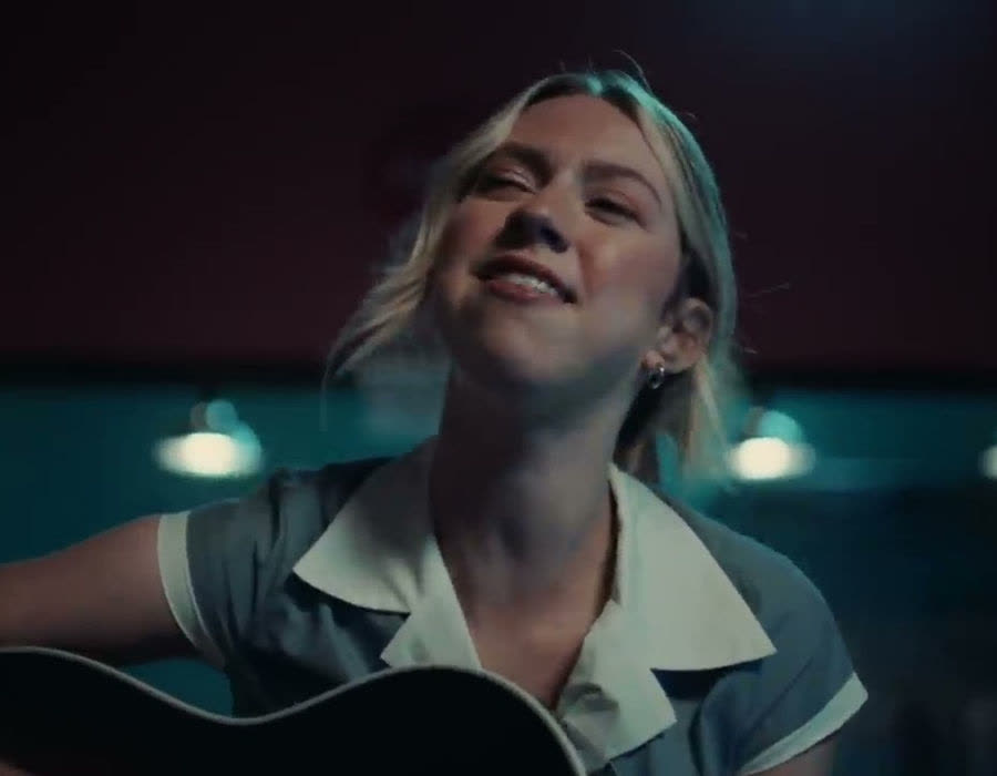 Student performing with guitar